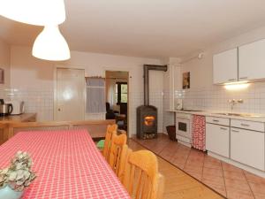 a kitchen and dining room with a table and a fireplace at Spacious Holiday Home in Menkhausen near Ski Area in Schmallenberg