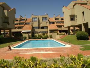 a swimming pool in front of some apartment buildings at Inviting Apartment in Playa de Pals with Pool in Begur