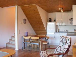 a kitchen and living room with a table and chairs at Spacious Apartment in Niedersfeld near Lake in Winterberg