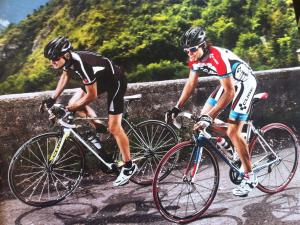 two men riding their bikes on a bridge at Beautiful Cottage in Pescia in San Quirico
