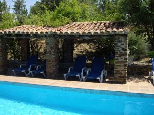 a gazebo with chairs next to a swimming pool at Rural Farmhouse in Valencia de Alc ntara with Pool in La Borrega