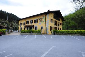 a building with a parking lot in front of it at Hotel Rural Bereau in Lesaka