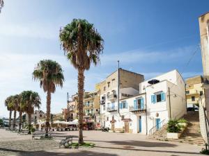 a city street with palm trees and buildings at Holiday home in Santa Flavia with terrace in Santa Flavia
