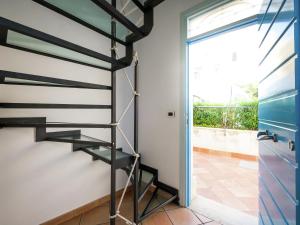 a spiral staircase in a house with a sliding glass door at Holiday home in Santa Flavia with terrace in Santa Flavia