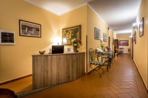 a hotel lobby with a reception desk and chairs at B&B Antiche Armonie in Florence