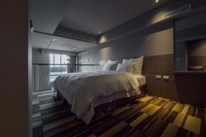 Postel nebo postele na pokoji v ubytování Watermark Hotel Kaohsiung Main Station