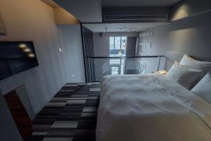 Postel nebo postele na pokoji v ubytování Watermark Hotel Kaohsiung Main Station