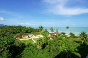 an aerial view of a resort with palm trees and the ocean at Bamboo Resort in Khanom