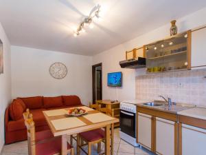 a kitchen and living room with a couch and a table at Apartments Špadići in Poreč