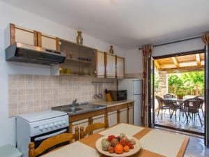 a kitchen with a table with a bowl of fruit on it at Apartments Špadići in Poreč