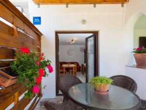 a patio with a table and chairs and flowers at Apartments Špadići in Poreč