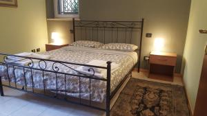 a bedroom with a bed with a wrought iron frame at Casa Barca in Verona