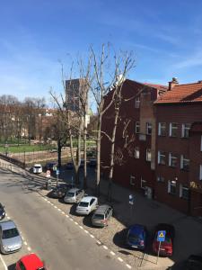 a group of cars parked in a parking lot at Centrum Apartament in Gdańsk