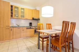 a kitchen with a dining room table and chairs at Apartment Katerina in Medulin