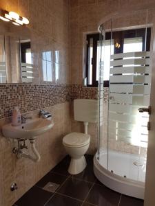a bathroom with a toilet and a sink and a shower at Apartment Sunset in Zadar +29 photos