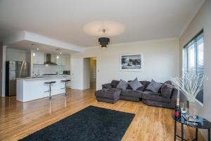 a living room with a couch and a kitchen at Indian Ocean Retreat in Alkimos