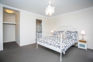 a bedroom with a white bed in a room at Indian Ocean Retreat in Alkimos