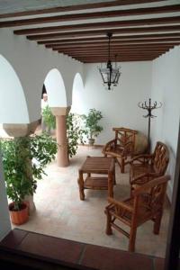 a patio with chairs and a table and a bench at Casa Maika in Montoro