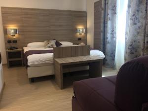 Postel nebo postele na pokoji v ubytování Coccodrillo Hotel & Apartments