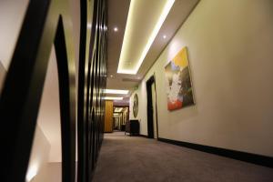 a hallway in an office building with a painting on the wall at Hotel Delta in Durrës