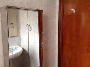 a bathroom with a shower and a sink and a mirror at Habitaciones Baobab in Rubí +40 photos