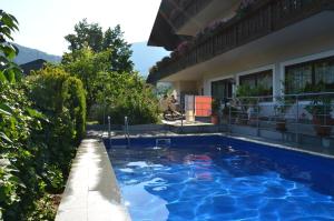 a swimming pool in the backyard of a house at Bed&Breakfast Pension Hilpold in Lana