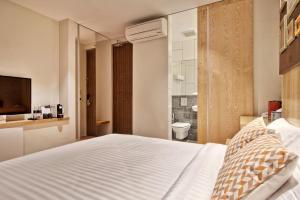 Postel nebo postele na pokoji v ubytování Timez Hotel Melaka