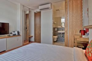 Postel nebo postele na pokoji v ubytování Timez Hotel Melaka