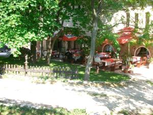 a backyard with a wooden fence and a table and benches at Only Adults- RAI in Golden Sands