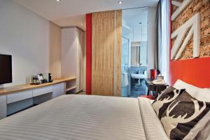 Postel nebo postele na pokoji v ubytování Timez Hotel Melaka