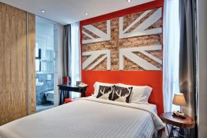 Postel nebo postele na pokoji v ubytování Timez Hotel Melaka