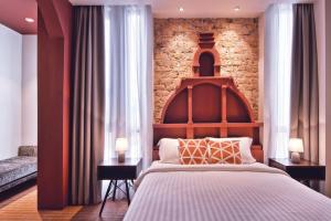 Postel nebo postele na pokoji v ubytování Timez Hotel Melaka