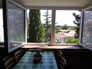 a dining room with a table and three windows at Apartments Kavan in Barbariga +25 photos