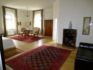 a living room with a table and chairs and a dining room at Schloss Hotel Wallhausen in Wallhausen