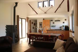 a kitchen and dining room with a table and chairs at Gite Le chataignier in Luttenbach-près-Munster