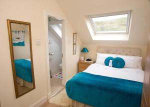 a bedroom with a bed with a window and a mirror at Craig Park House in Airdrie