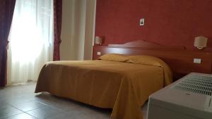 Postel nebo postele na pokoji v ubytování Hotel Dei Cappuccini