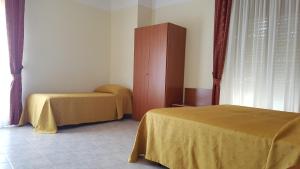 Postel nebo postele na pokoji v ubytování Hotel Dei Cappuccini