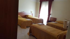 Postel nebo postele na pokoji v ubytování Hotel Dei Cappuccini
