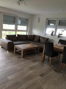 a living room with a couch and a table at Haus Yasmin in Kressbronn am Bodensee