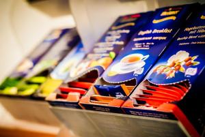 a row of blue and orange packets of food at Hotel Centrale in Trieste