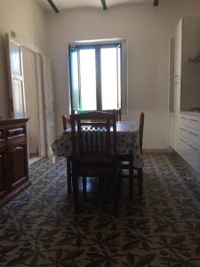 a dining room with a table and chairs and a window at Casa Cardi in Sperlonga