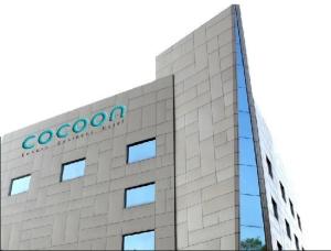 a building with a google sign on the side of it at Cocoon Luxury Business Hotel in Dhanbād