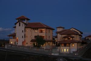 a large house with a building in the evening at Asti Arthotel in Sinemorets