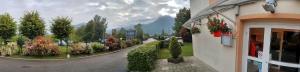 a building with a view of a street with plants at Hotel Amys Voreppe in Voreppe