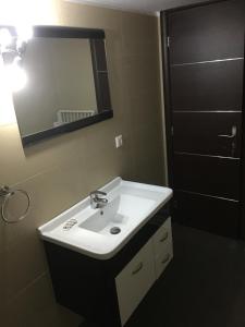 a bathroom with a sink and a mirror and a shower at Boussetil Apartment in Tinos +35 photos