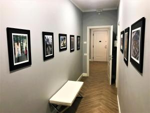 a hallway with a bench and pictures on a wall at B&B Residenza Ermanni in Verona