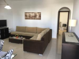 a living room with a couch and a table at Boussetil Apartment in Tinos