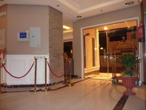 a lobby with a red rope in a building at Low Light Suites in Al Kharj
