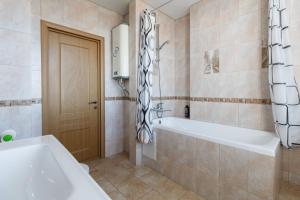 a bathroom with a tub and a shower and a sink at Nataliya's flat apartments Shcherbakovskiy pereulok 7 in Kazan